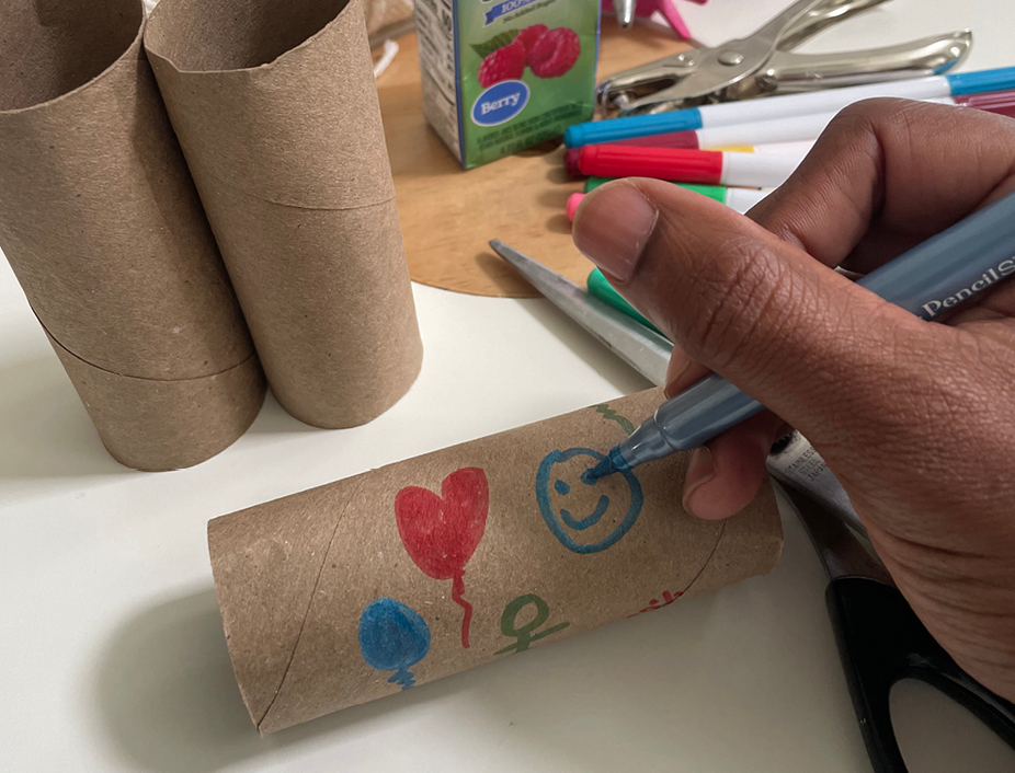 Decorating and drawing on paper rolls to decorate the binoculars